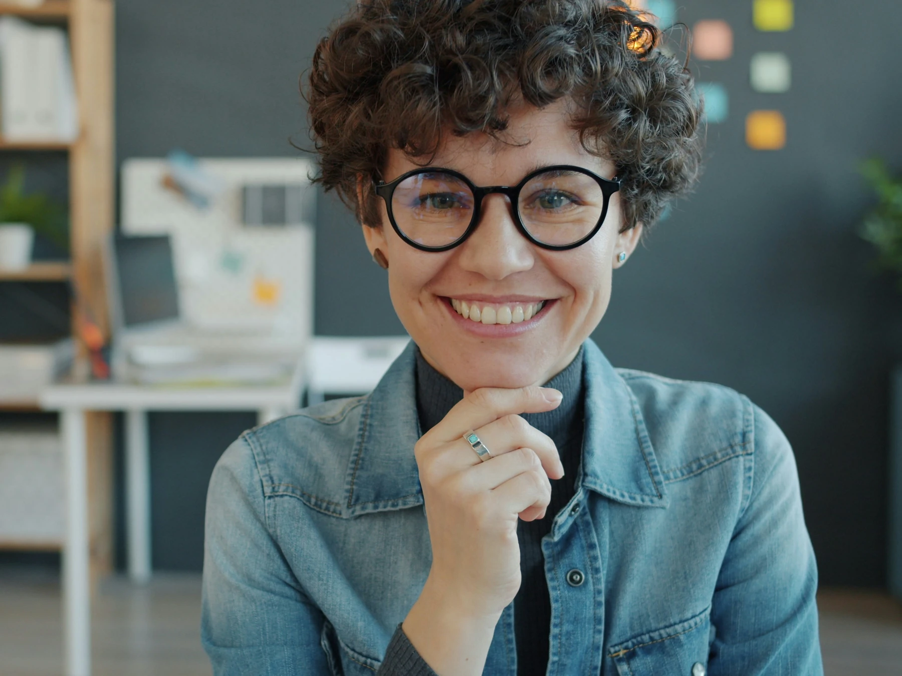 Profissional usando óculos de grau sorrindo em um escritório